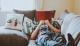 person laying on sofa while reading book